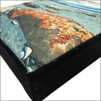 textile print of seaside boulders and embroidered sea life